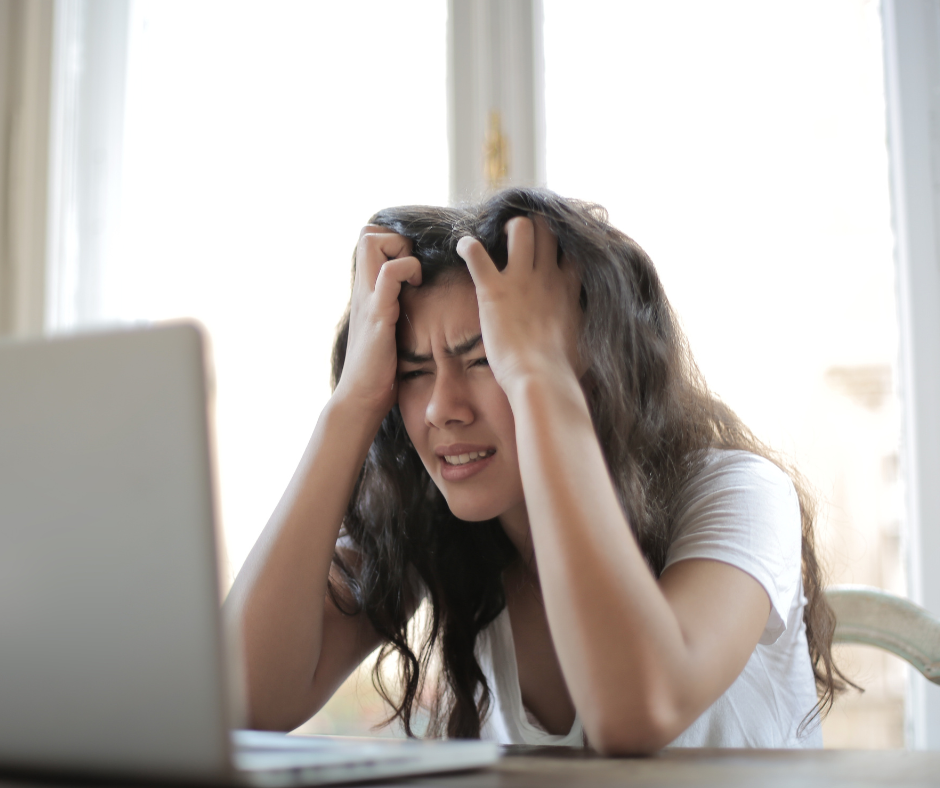 Stressed woman at a computer | Neuroscience can't heal disconnection
